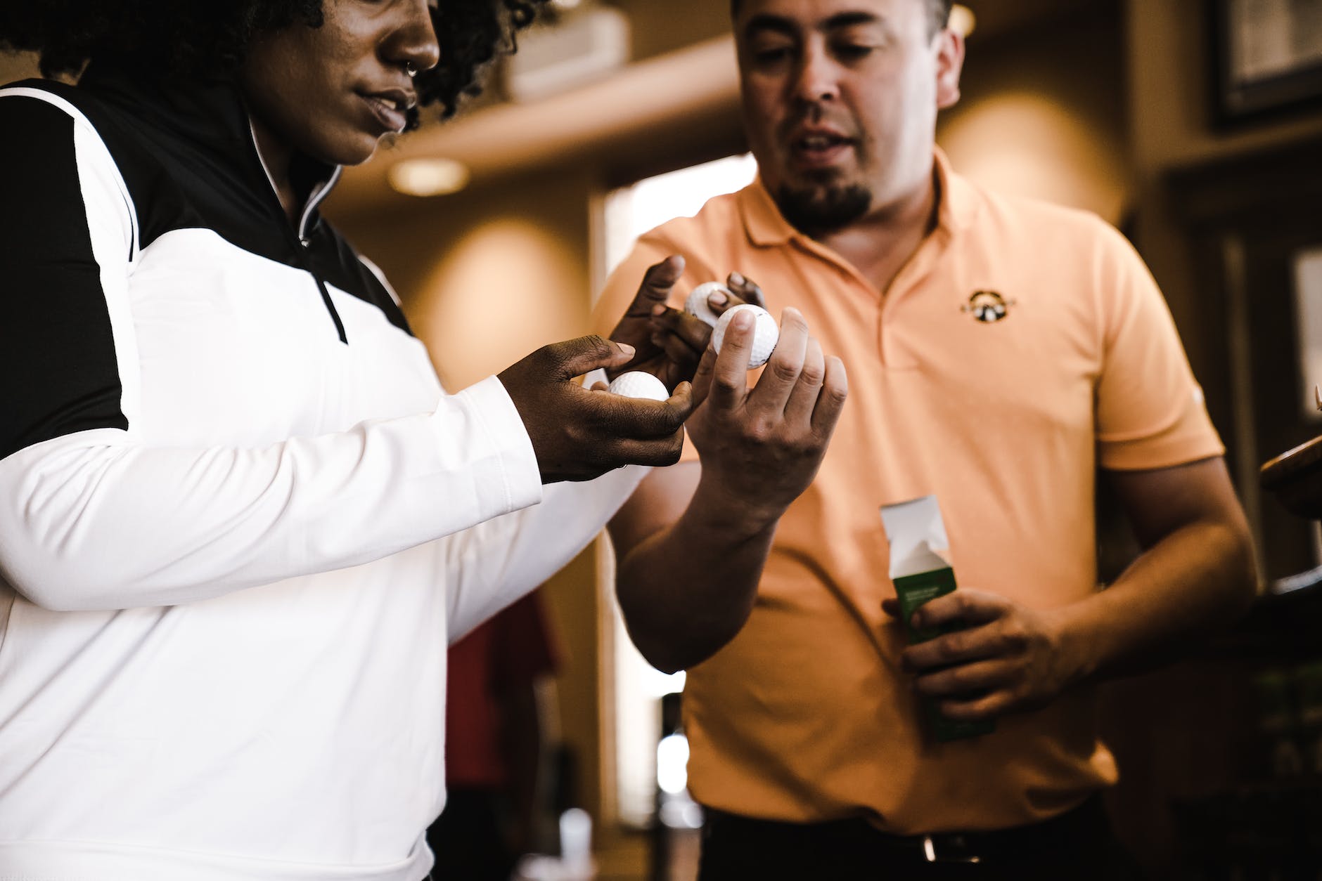 woman and man looking at golf balls